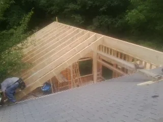 Framing a new roof addition that ties into an existing shingle roof in Drury