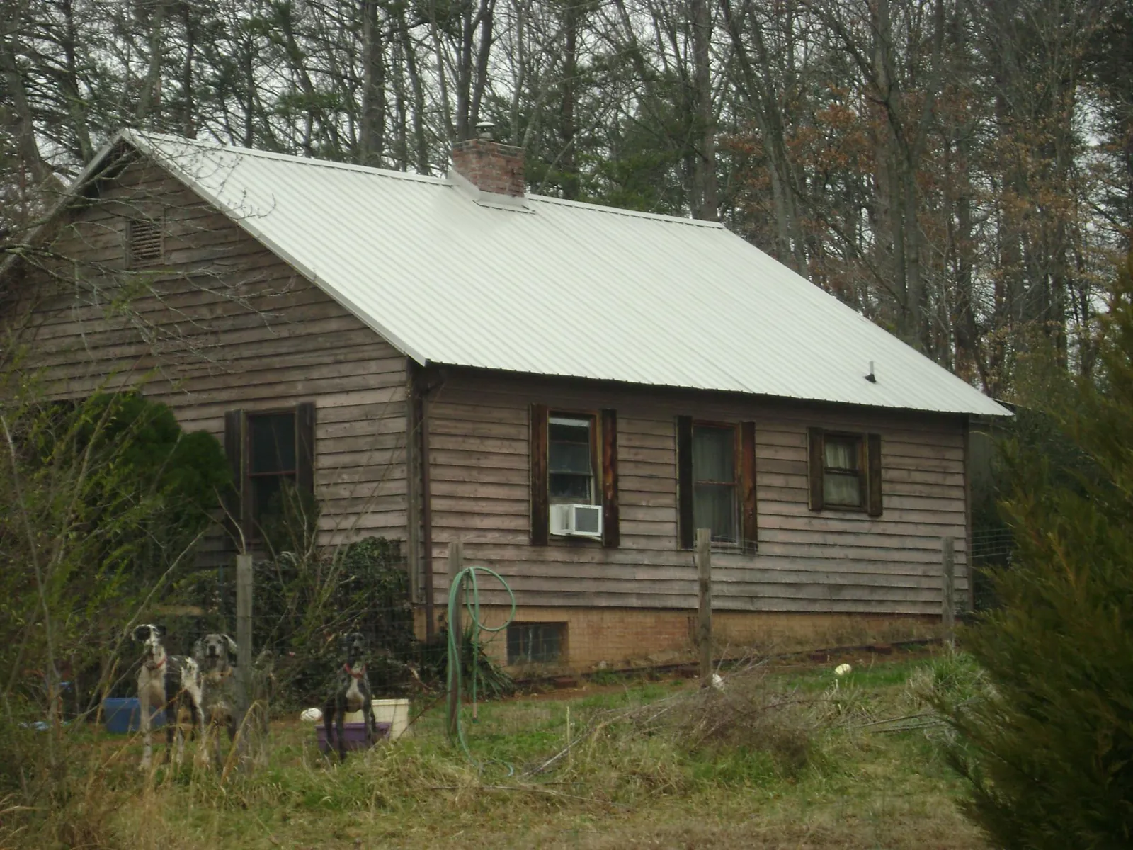 White metal roof on an old wood sided farmhouse, from a Metal Roof Installation job in Drury